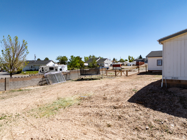 1637 East Midvalley Road Enoch, UT 84721 - Photo 47 of 48 Expansive rear yard with a full block wall and wood fence