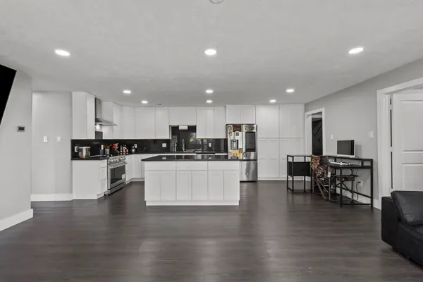 a kitchen with stainless steel appliances granite countertop a sink stove and refrigerator