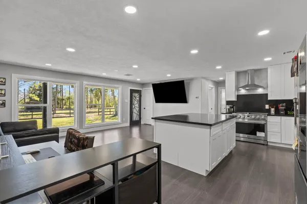 a large kitchen with a sink and cabinets