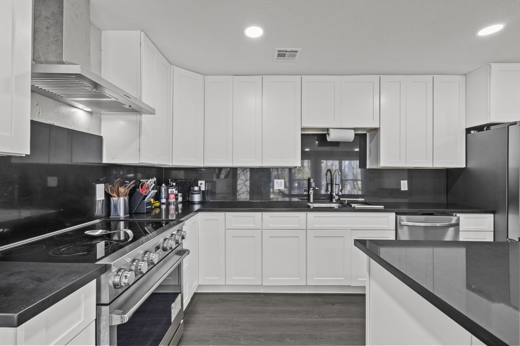 5406 South Tower Road Santa Fe, TX 77517 - Photo 15 of 46 a kitchen with granite countertop a sink stainless steel appliances and white cabinets