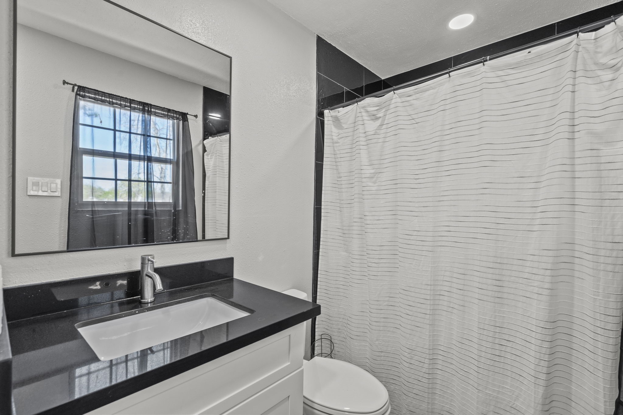 5406 South Tower Road Santa Fe, TX 77517 - Photo 19 of 46 a bathroom with a granite countertop sink toilet and mirror