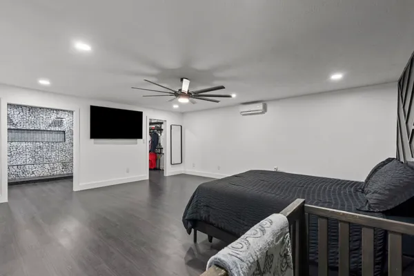 a hallway with a book shelf and a chandelier
