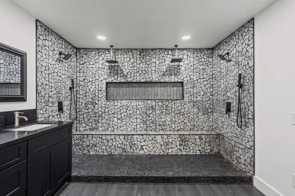 a bathroom with a sink a mirror and shower