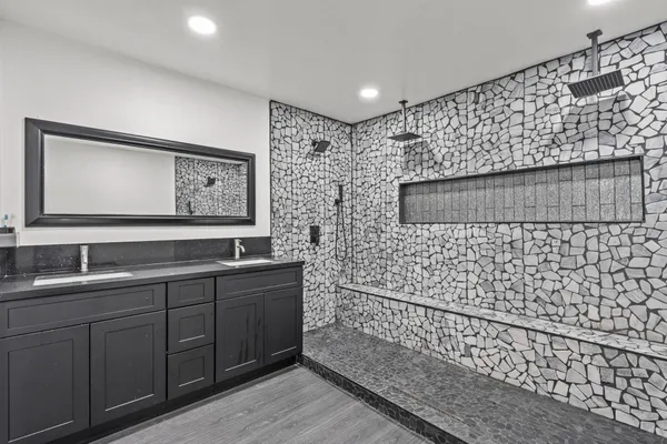 a bathroom with a sink a toilet and a mirror