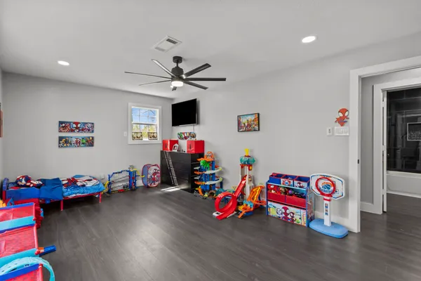 a kids room that has a bed and a window