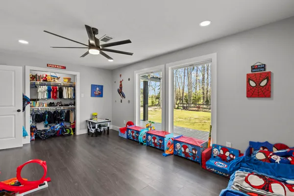 a bathroom with a granite countertop sink a toilet a mirror and bathtub