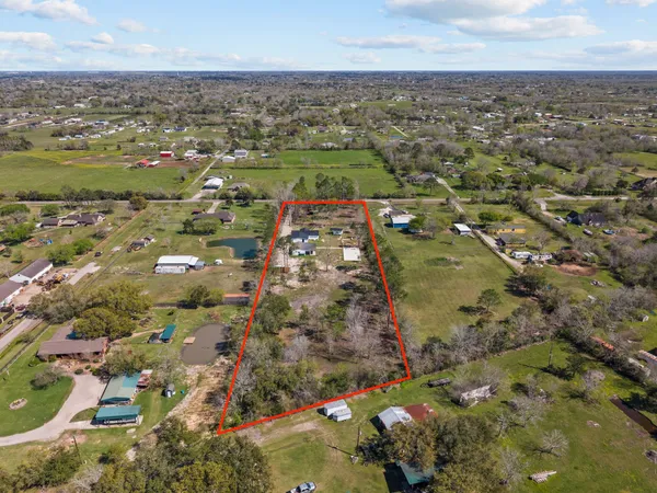 an aerial view of residential houses with outdoor space
