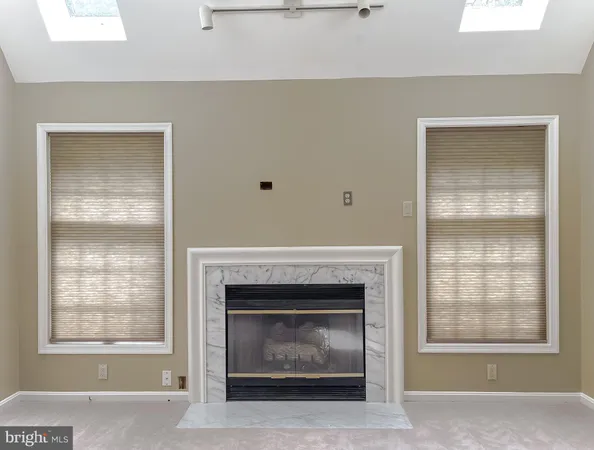 a living room with a fireplace and windows
