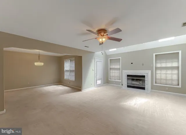 a view of a livingroom with a fireplace and window