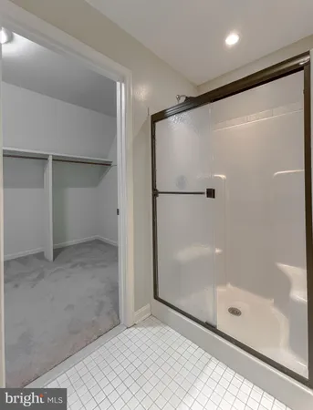 a bathroom with a glass shower door