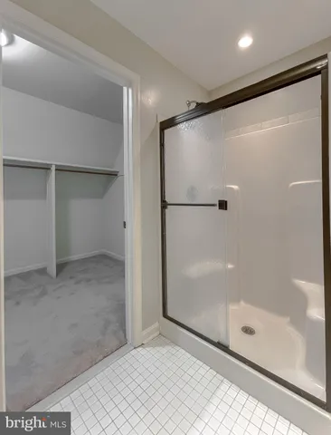 a bathroom with a glass shower door