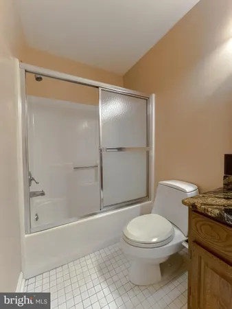 a white toilet sitting next to a bath tub