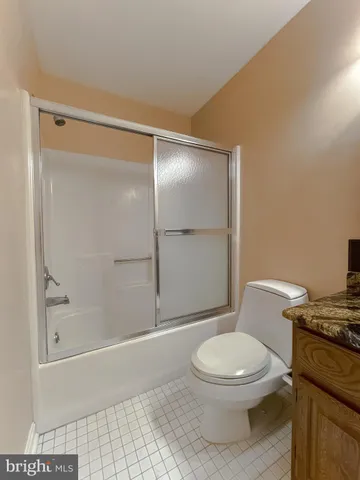 a white toilet sitting next to a bath tub