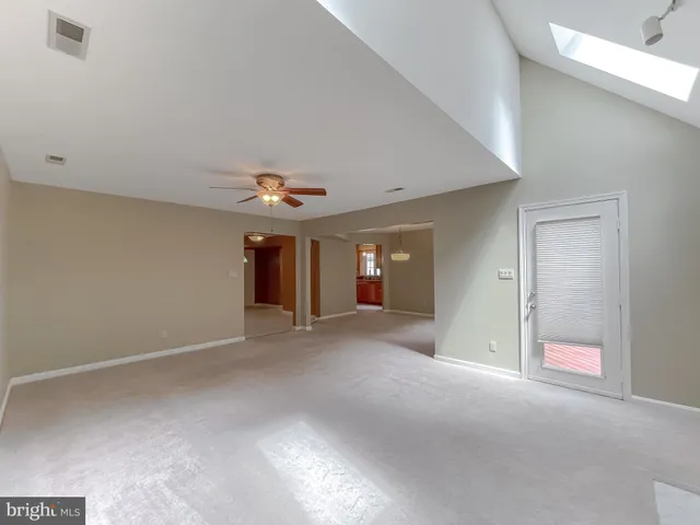 a view of a livingroom with an empty space and a ceiling fan