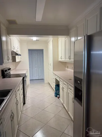 a kitchen with stainless steel appliances granite countertop a refrigerator and a stove