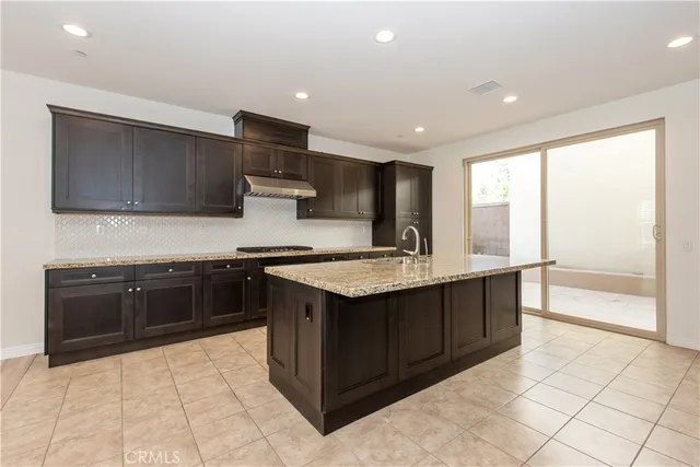a kitchen with stainless steel appliances granite countertop a sink and a stove