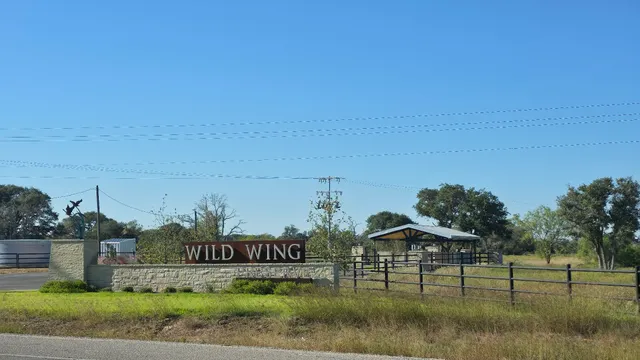 a view of a street with houses in the background