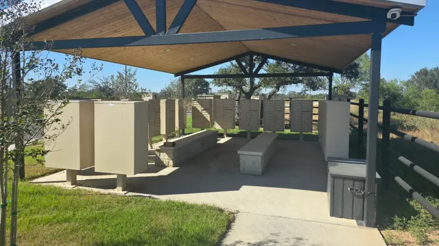 a view of a patio with a table and chairs under an umbrella