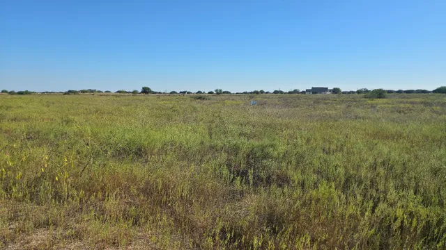 a view of a lake and green valley