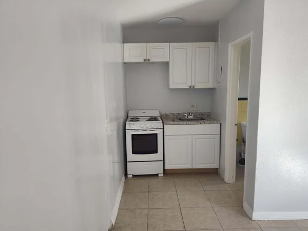 a utility room with sink dryer and washer
