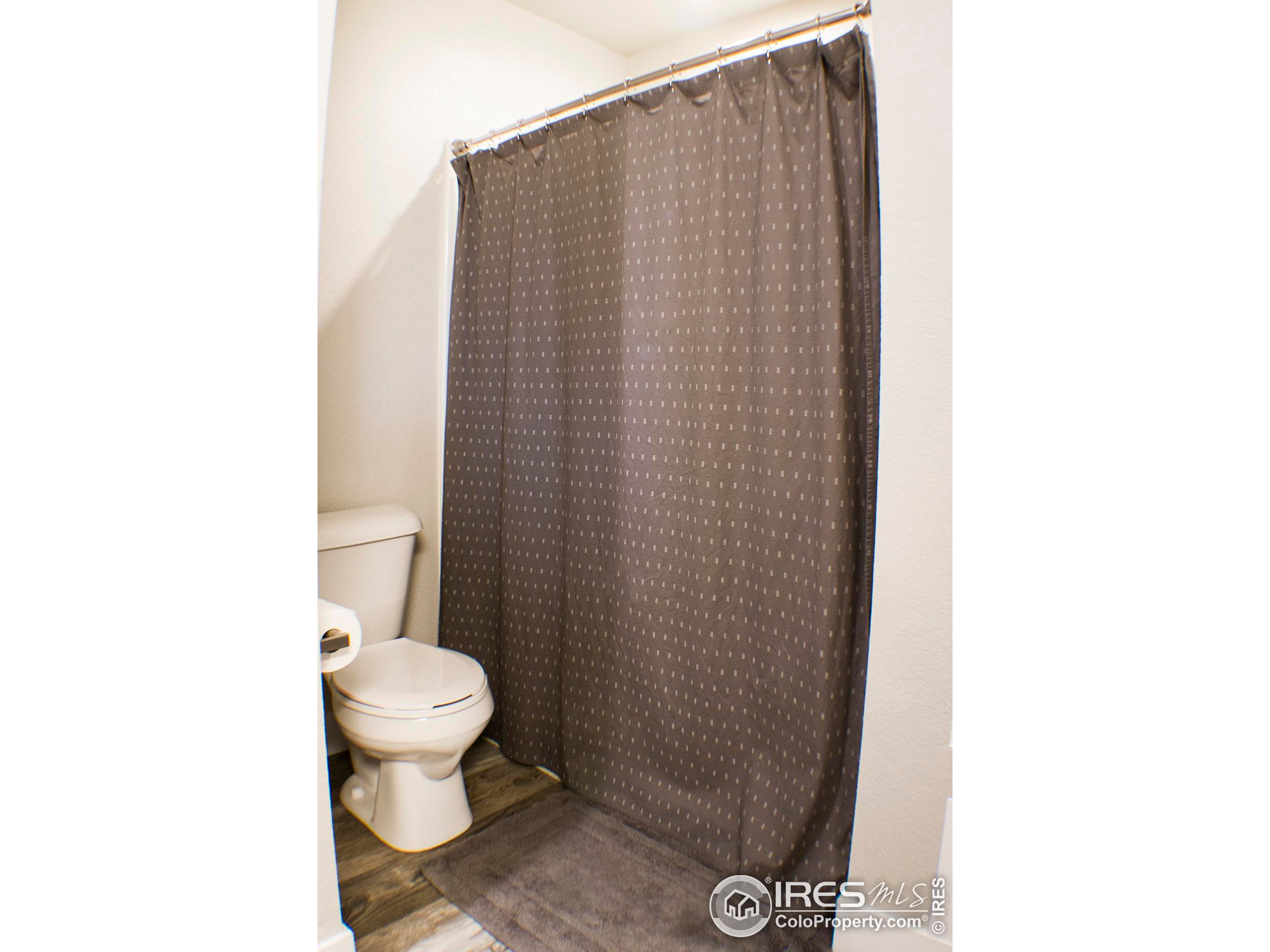 313 West Furry Street Holyoke, CO 80734 - Photo 13 of 23 a bathroom with a toilet and a shower