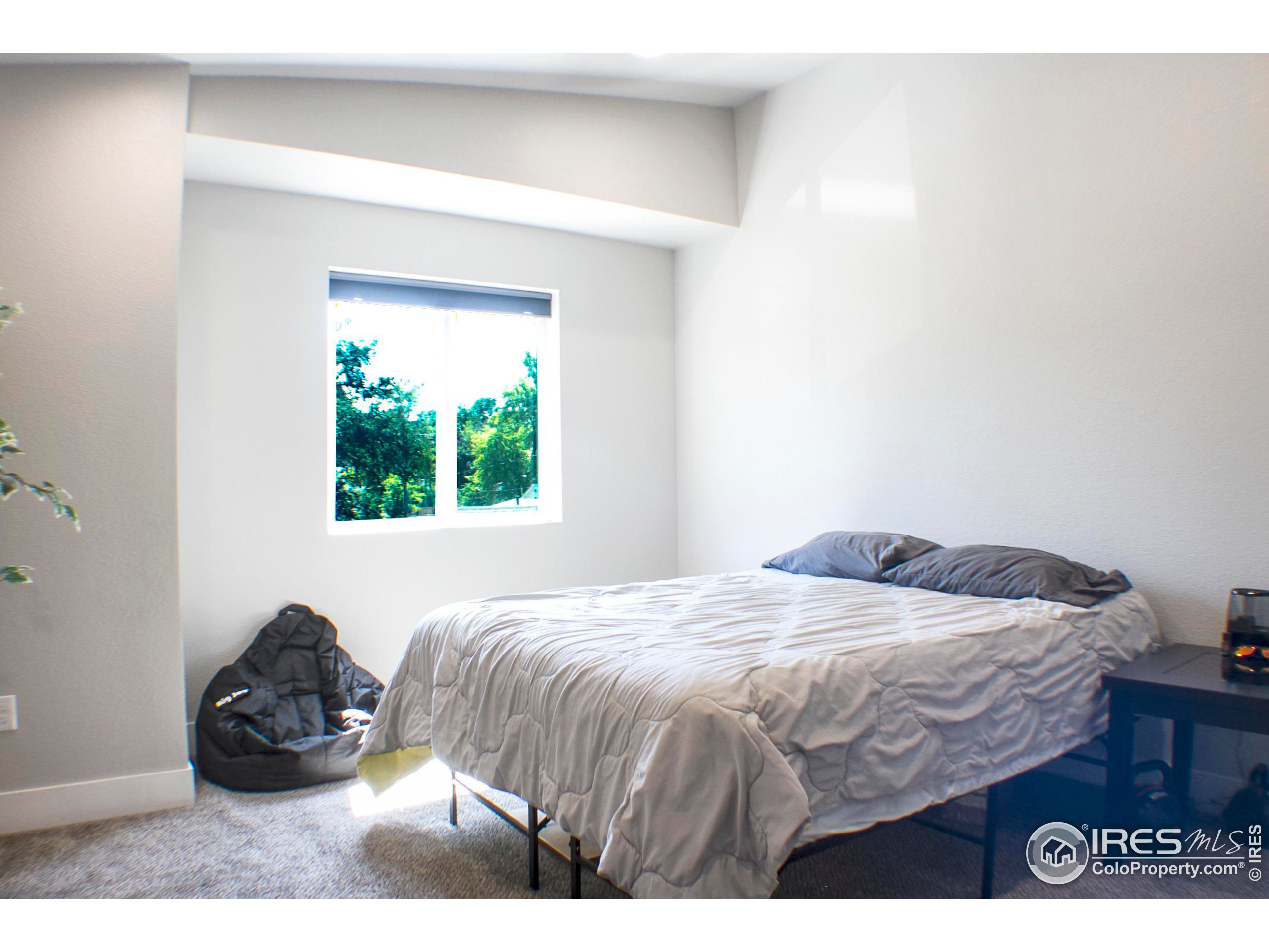 313 West Furry Street Holyoke, CO 80734 - Photo 15 of 23 a bedroom with a bed and a painting on the wall