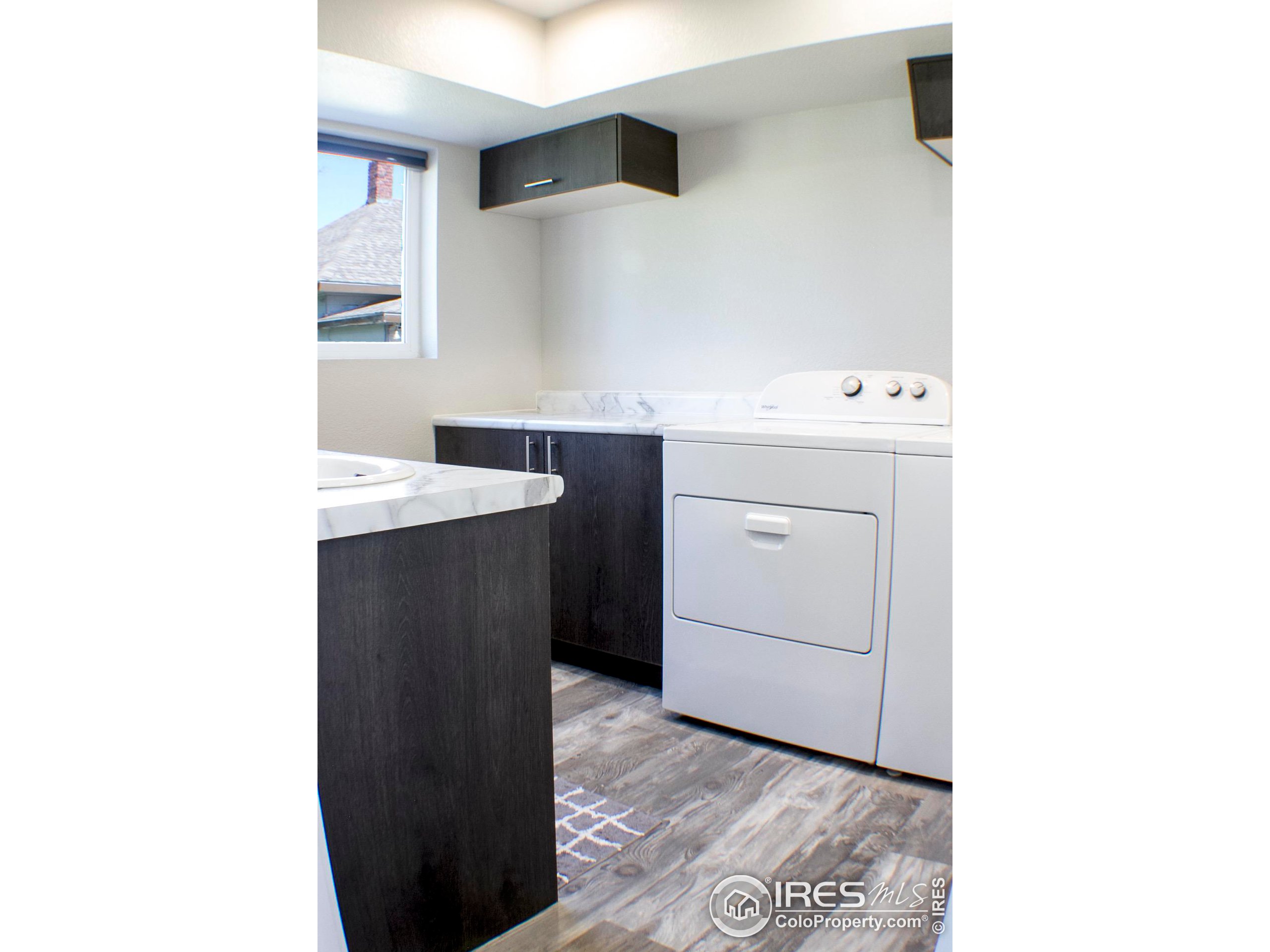 313 West Furry Street Holyoke, CO 80734 - Photo 19 of 23 a room with a sink cabinets and utility room