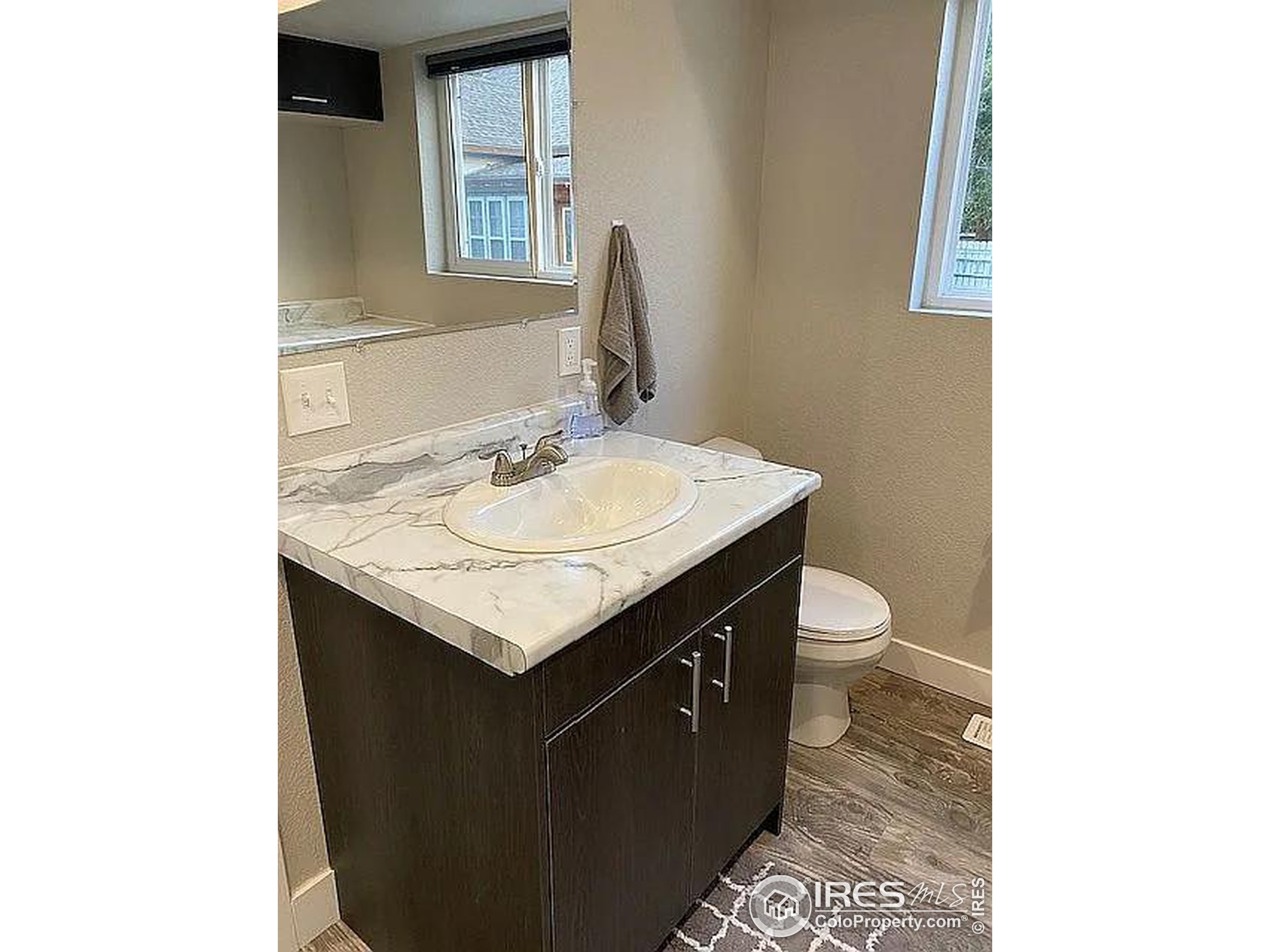 313 West Furry Street Holyoke, CO 80734 - Photo 21 of 23 a bathroom with a sink and a toilet