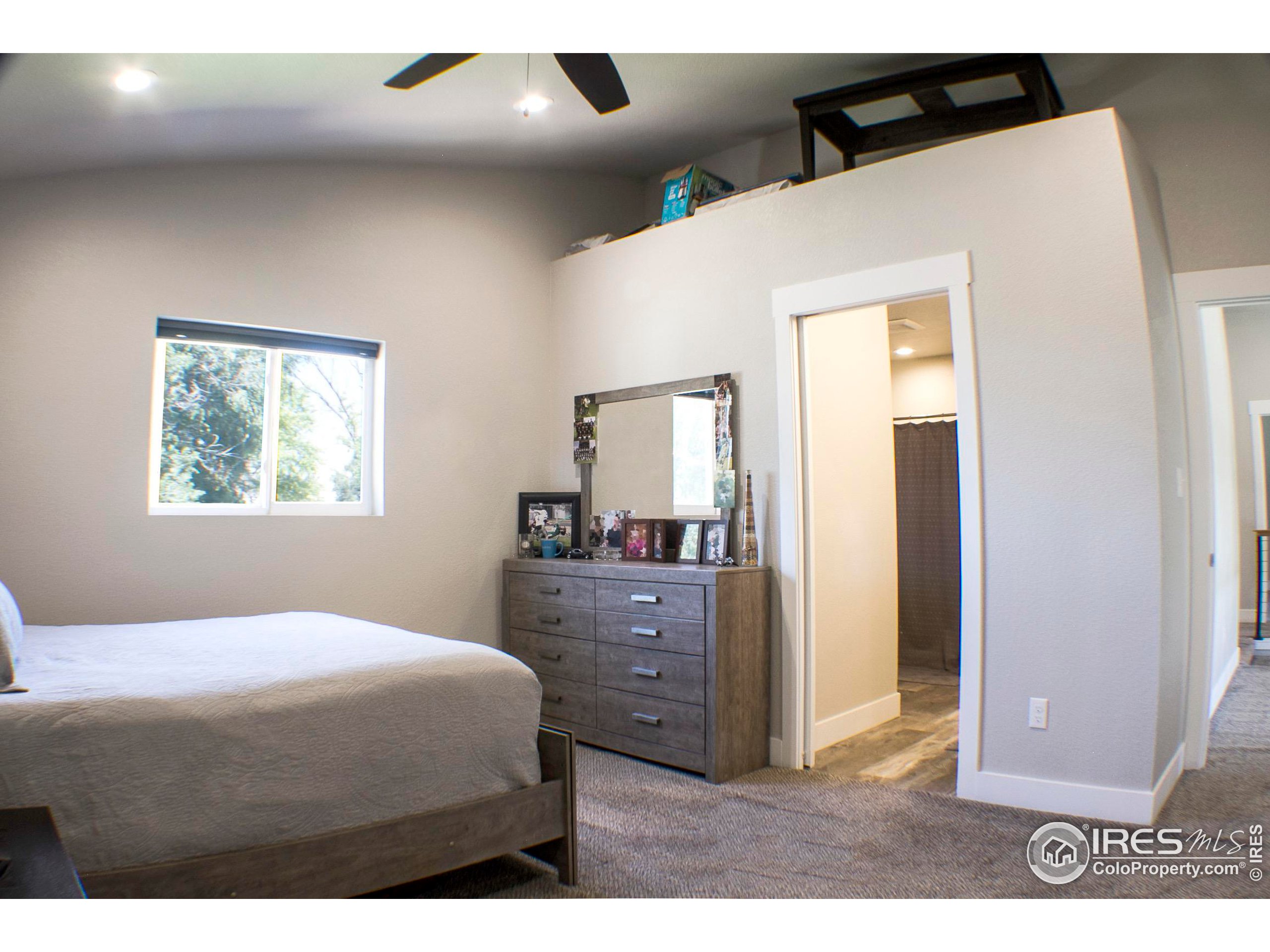 313 West Furry Street Holyoke, CO 80734 - Photo 9 of 23 a bedroom with a bed and a dresser