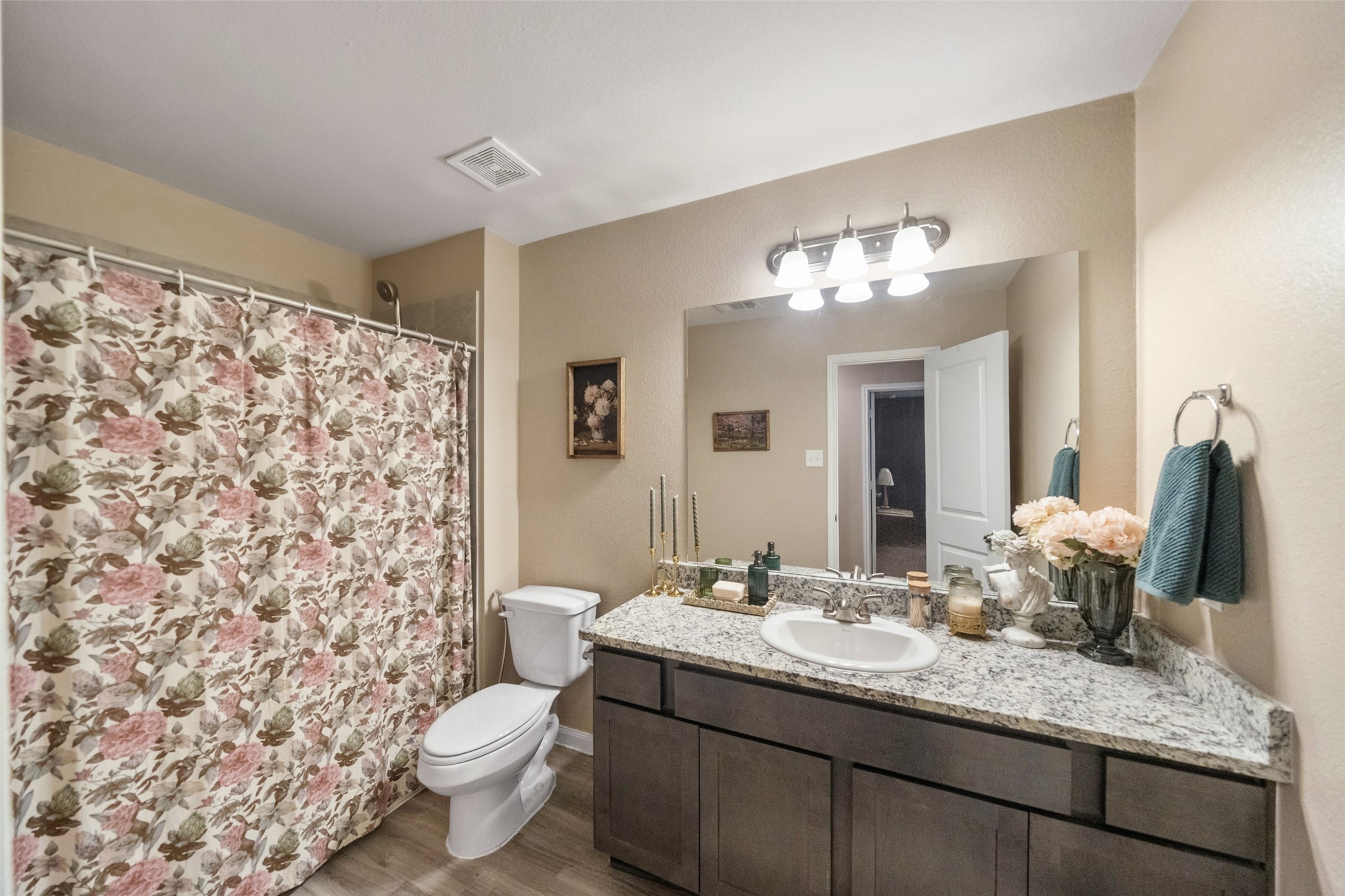 26431 Pin Oak Drive Hempstead, TX 77445 - Photo 21 of 32 Bright full bath with a wide vanity, granite-look countertop, and generous mirror for easy daily routines. Clean finishes and updated lighting keep the space fresh and functional.