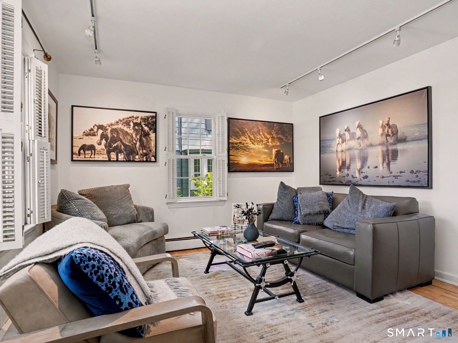 43 George Avenue Norwalk, CT 06851 - Photo 12 of 39 a living room with furniture a couch and paintings on the wall
