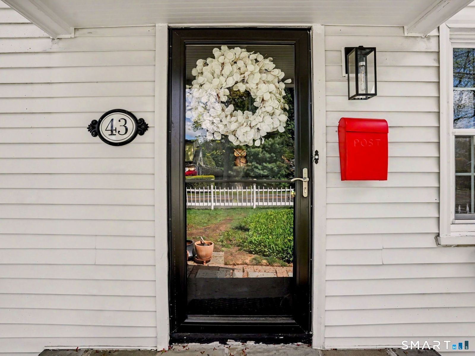 43 George Avenue Norwalk, CT 06851 - Photo 2 of 39 a view of door with a bench