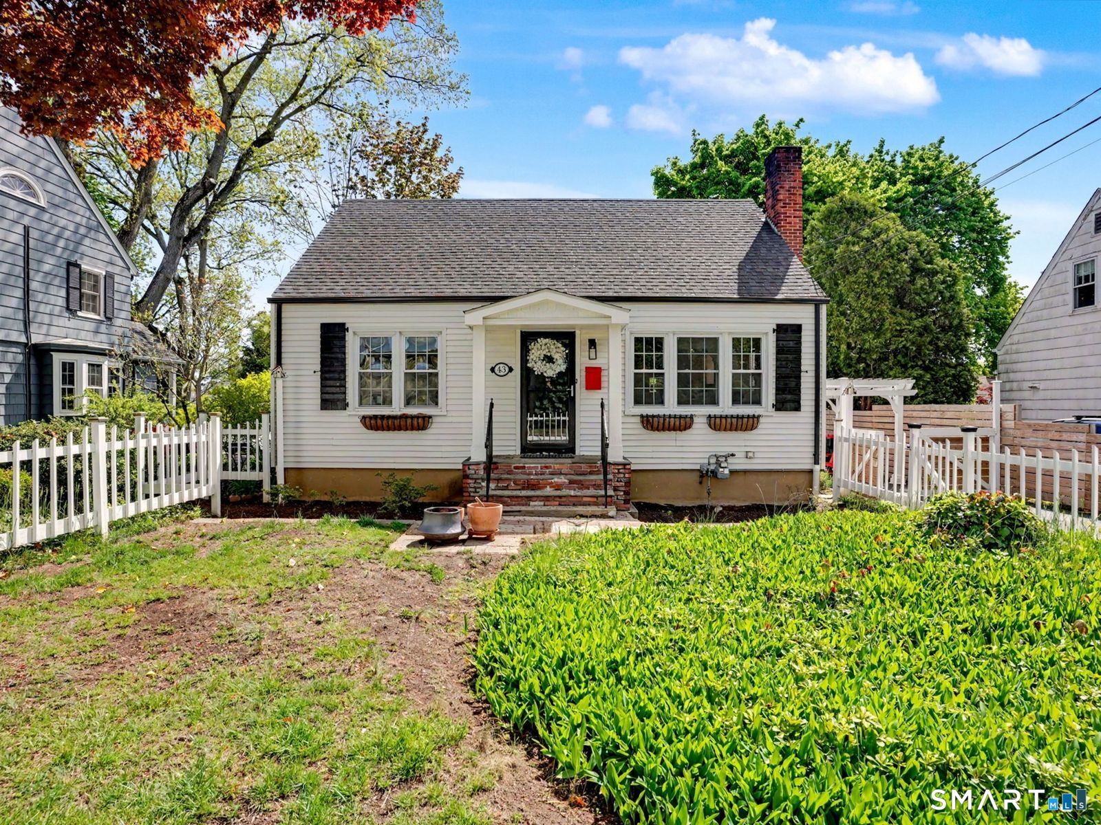43 George Avenue Norwalk, CT 06851 - Photo 37 of 39 front view of a house with a small yard