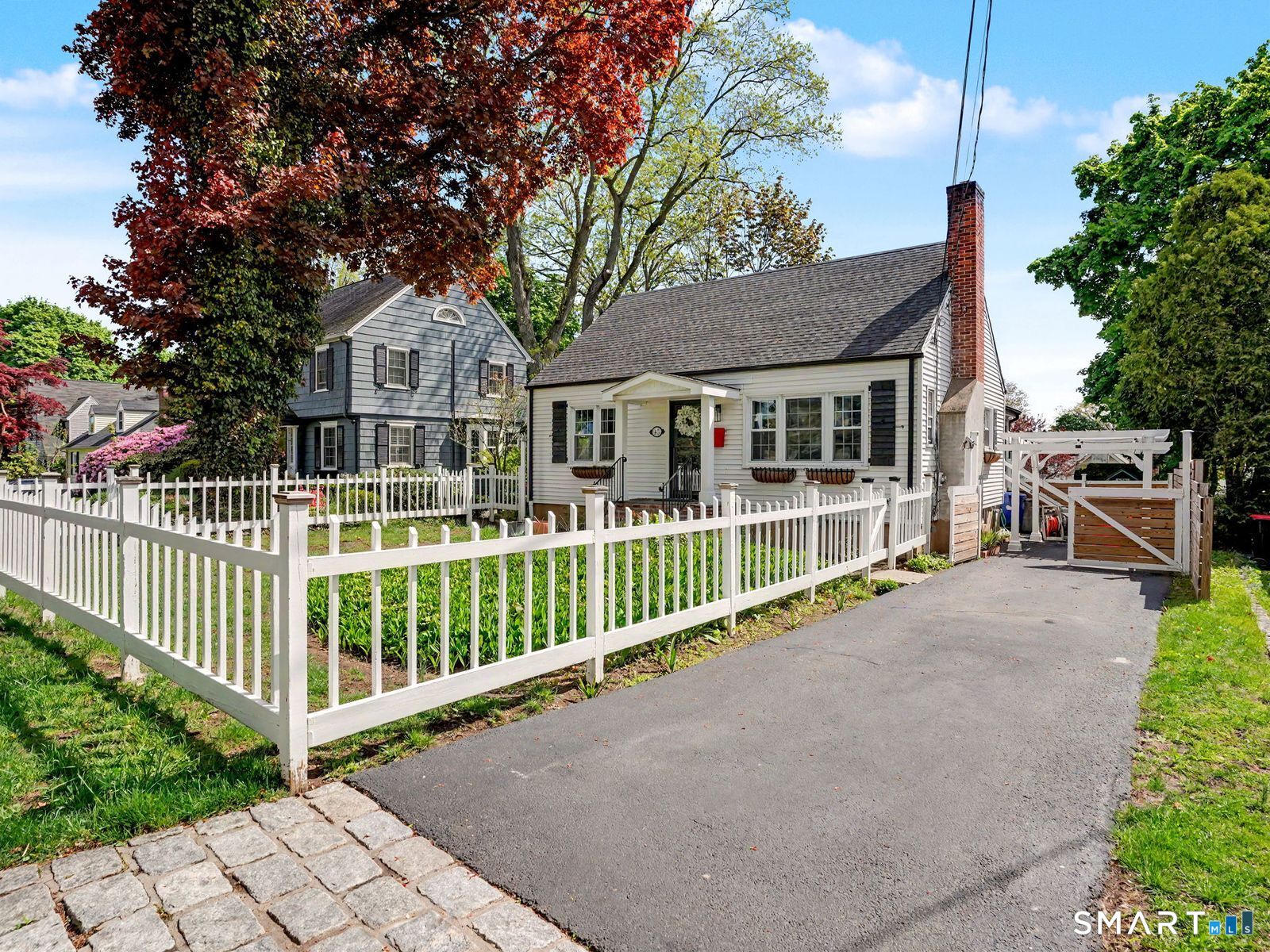 43 George Avenue Norwalk, CT 06851 - Photo 38 of 39 a front view of a house with a garden