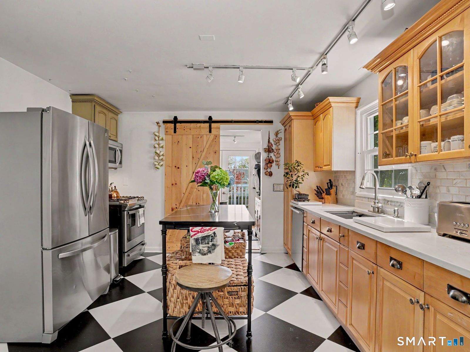 43 George Avenue Norwalk, CT 06851 - Photo 9 of 39 a kitchen with stainless steel appliances a refrigerator and a sink