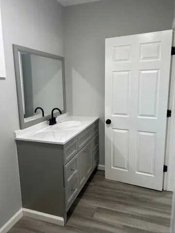 a utility room with a sink and mirror