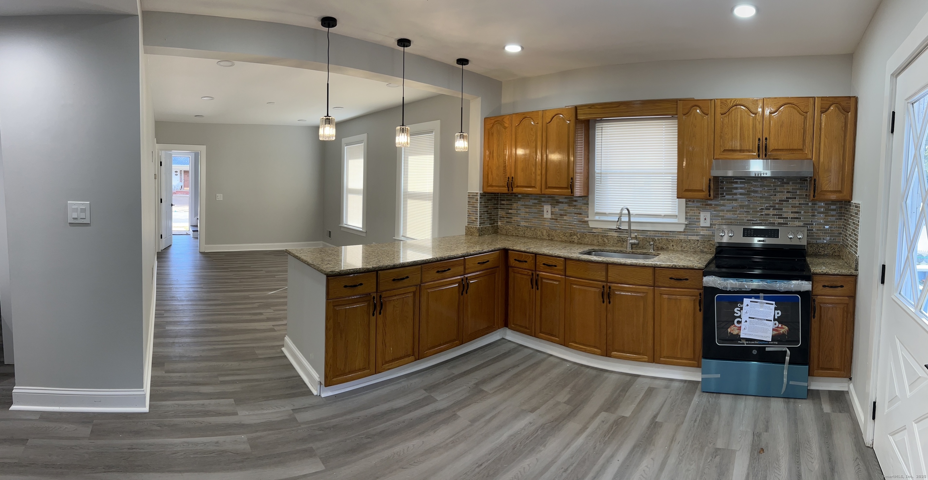 179 Westfield Avenue Ansonia, CT 06401 - Photo 5 of 12 a kitchen with stainless steel appliances granite countertop a sink a stove and a wooden floors