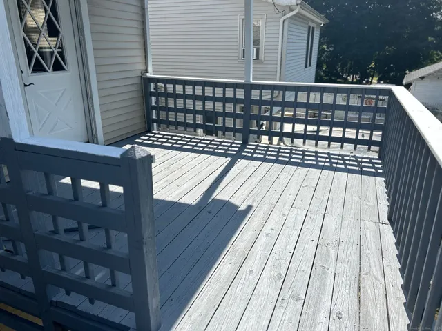 a view of a balcony with wooden floor