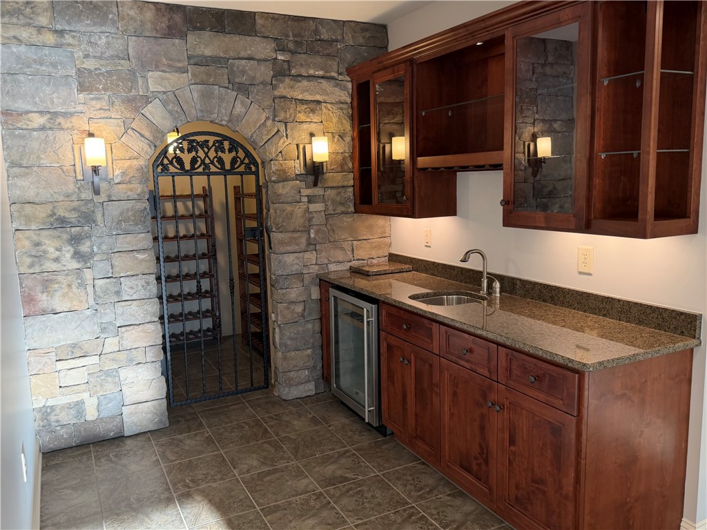 357 Stardust Lane Seneca, SC 29672 - Photo 33 of 50 Kitchenette/Wine Cellar - Rich wood cabinetry and stone accents define this refined home bar and wine cellar area.