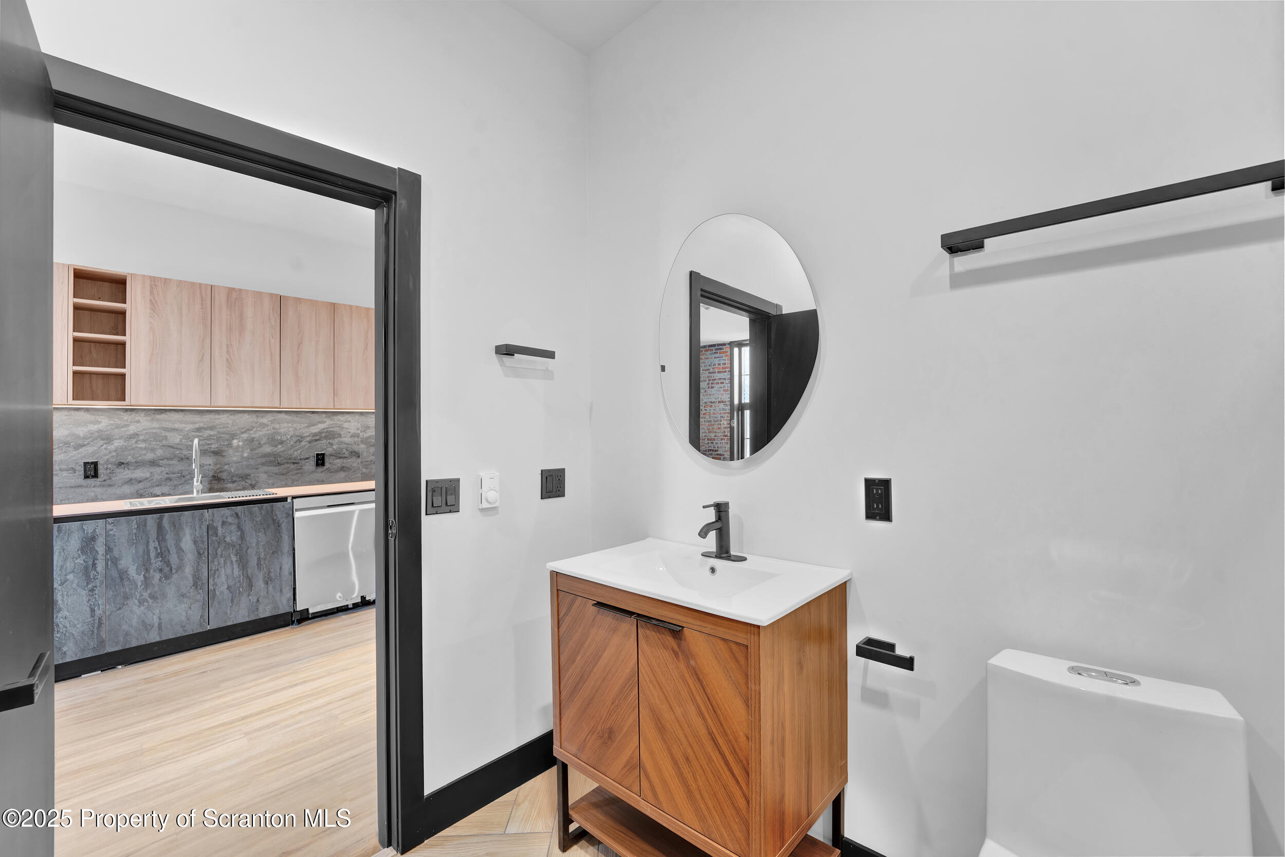 115 Penn Avenue, Unit 100 Scranton, PA 18503 - Photo 29 of 46 a bathroom with a sink a mirror and a toilet