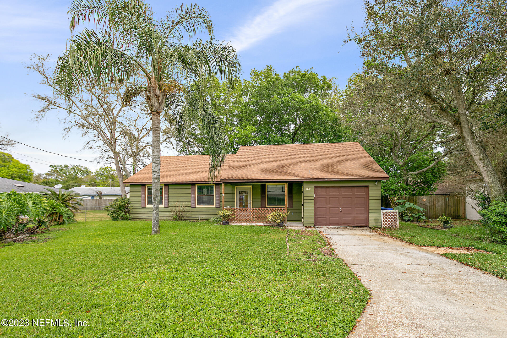 209 Jasmine Road St. Augustine, FL 32086 - Photo 1 of 35 a front view of a house with a garden and trees