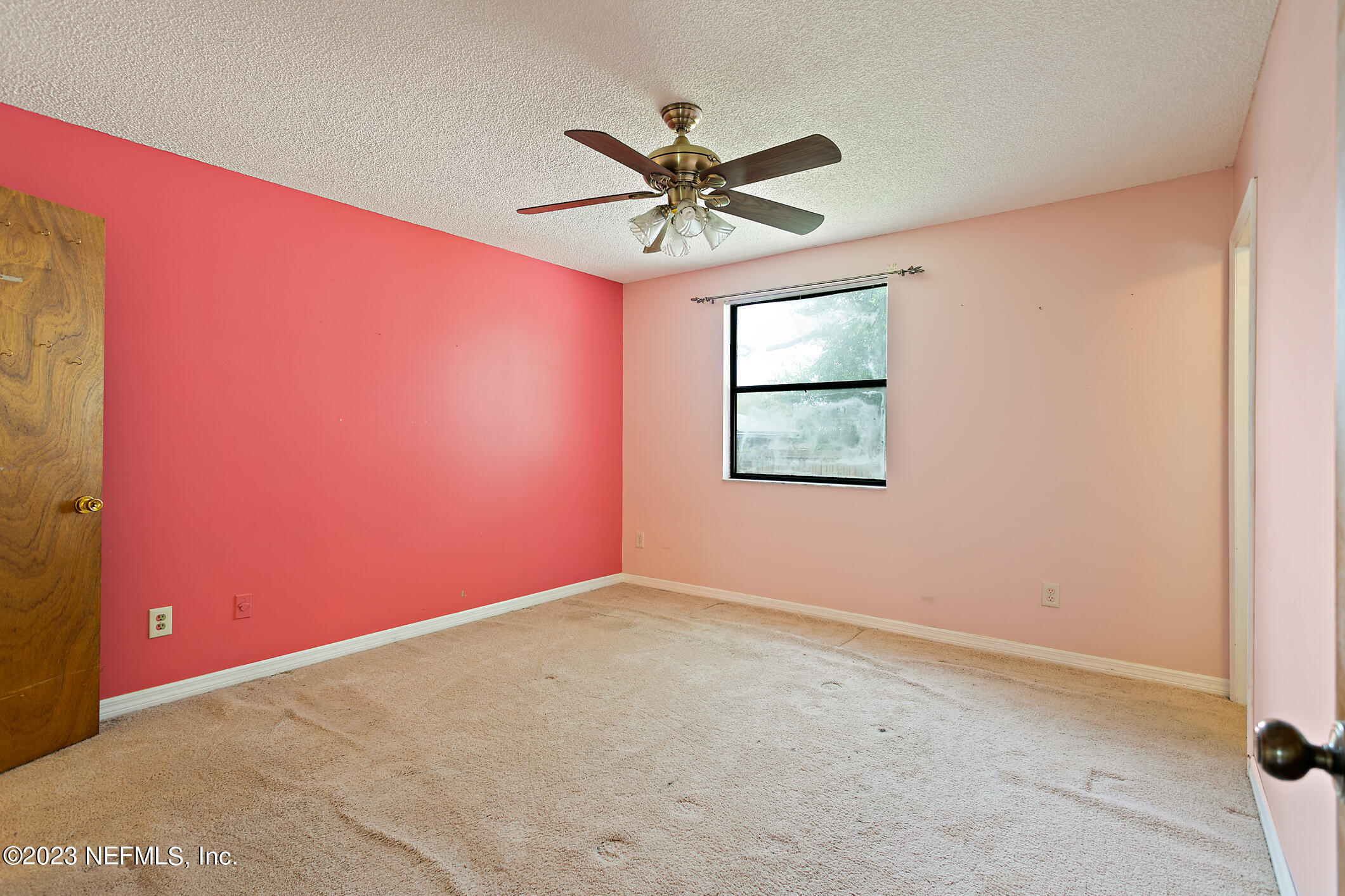 209 Jasmine Road St. Augustine, FL 32086 - Photo 21 of 35 an empty room with a window and a ceiling fan