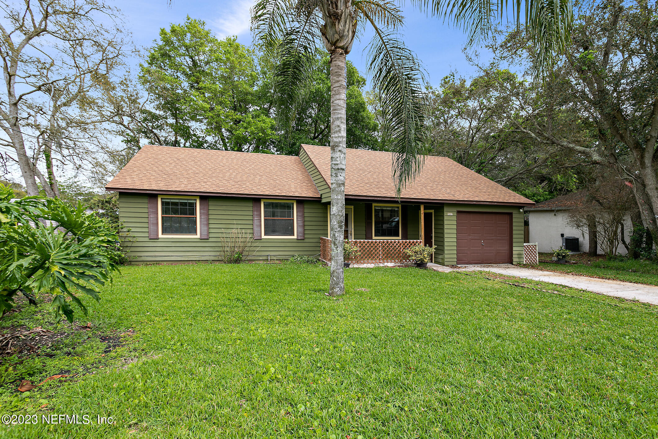 209 Jasmine Road St. Augustine, FL 32086 - Photo 3 of 35 a front view of a house with a garden and trees