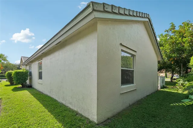 a view of a backyard with plants and a backyard