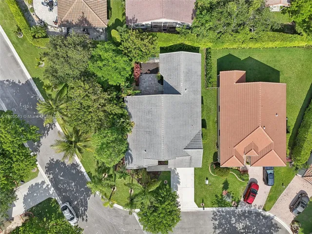 an aerial view of a house with outdoor space and a lake view