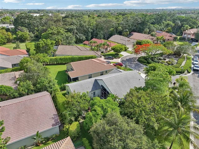 an aerial view of a house with yard swimming pool and outdoor seating