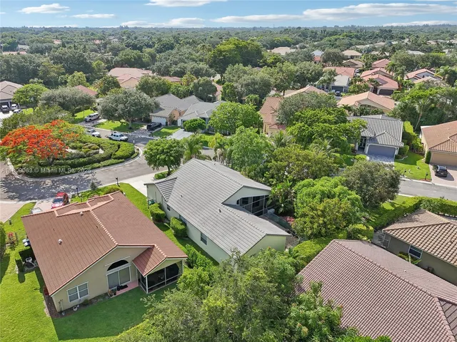 an aerial view of multiple houses with yard
