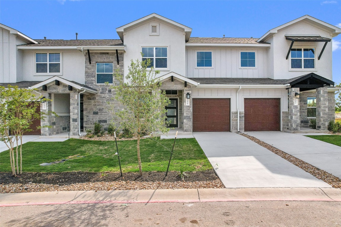 a front view of a house with a garden