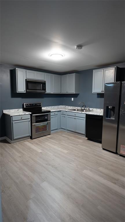 3171 Redwood Run Atlanta, GA 30349 - Photo 3 of 7 a large kitchen with stainless steel appliances granite countertop a stove top oven a sink dishwasher a refrigerator and a microwave oven