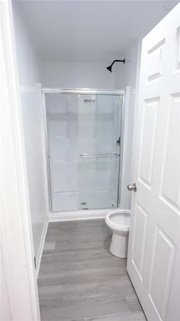 a bathroom with a toilet and a shower